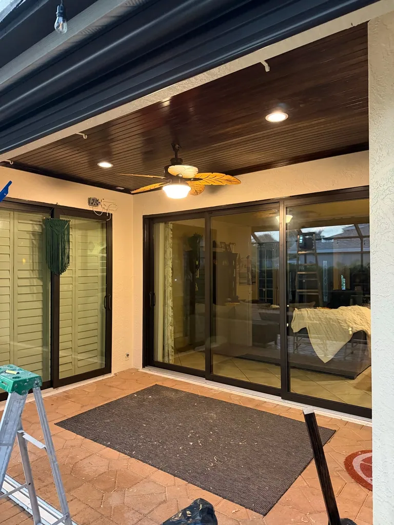 Dark wood ceiling paneling installed by Honey-Do Crew above a covered Naples lanai